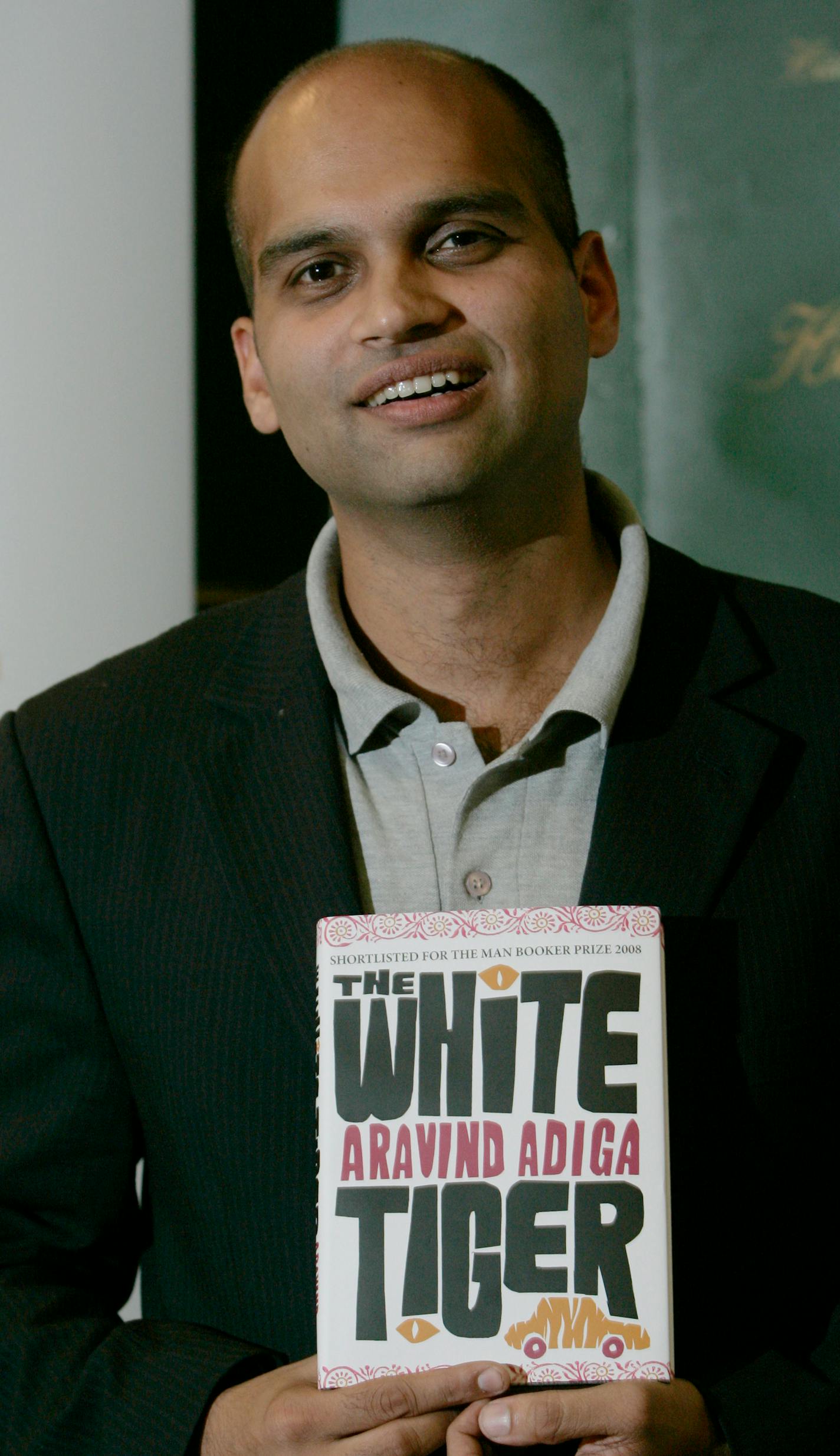 Indian author Aravind Adiga holds a copy of his book entitled 'The White Tiger ' during a media event in London, Tuesday, Oct. 14, 2008 .