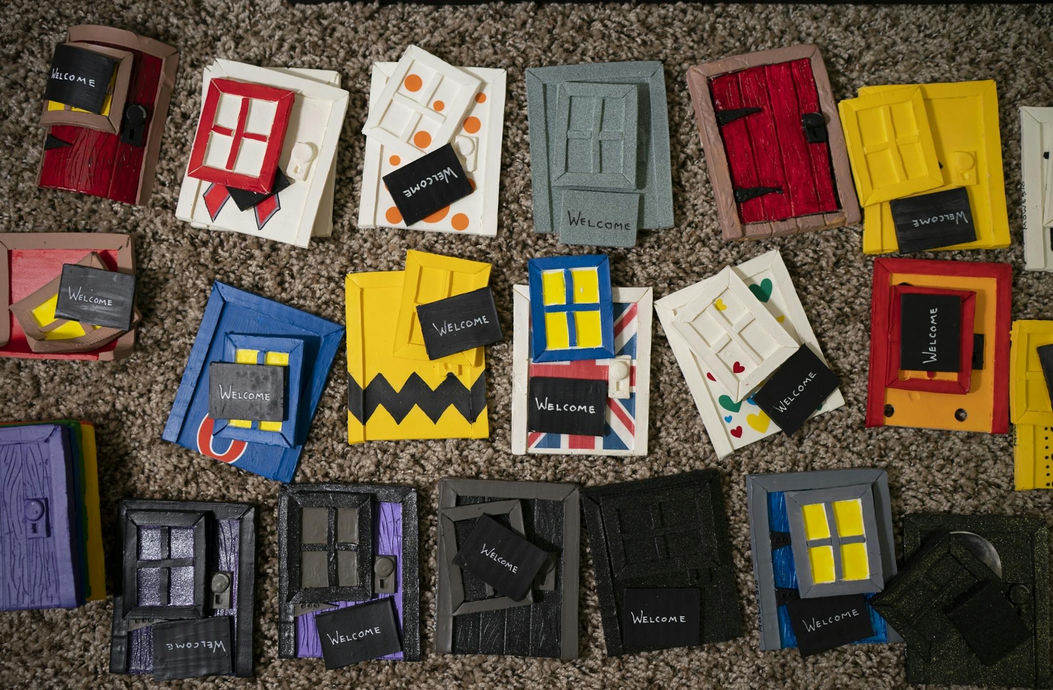 An array of mouse doors painted and awaiting installation.
