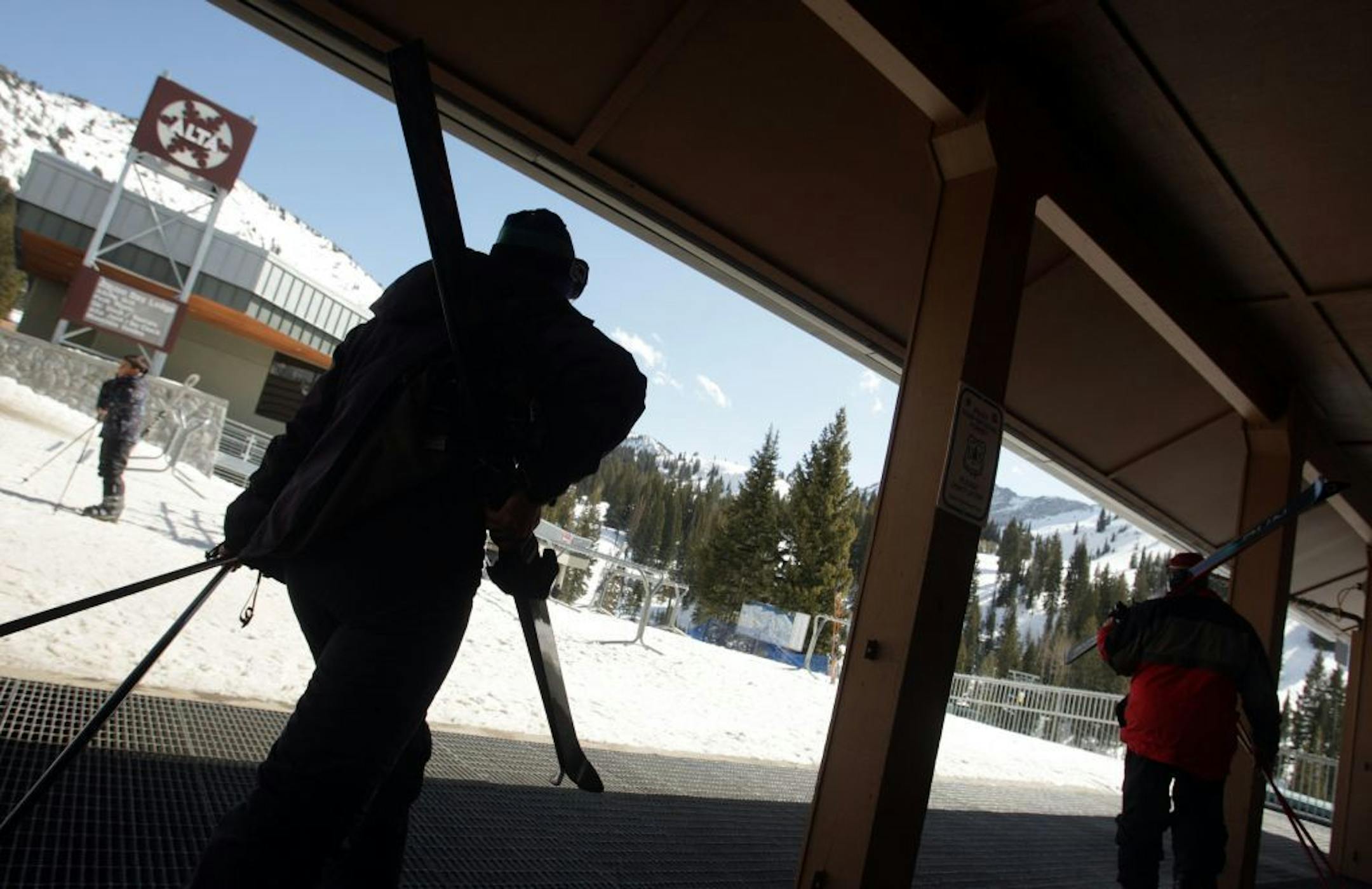 FILE - In this Feb. 19, 2013 file photo, a skier walks to the lift at Alta Ski Resort in Little Cottonwood Canyon near Salt Lake City.