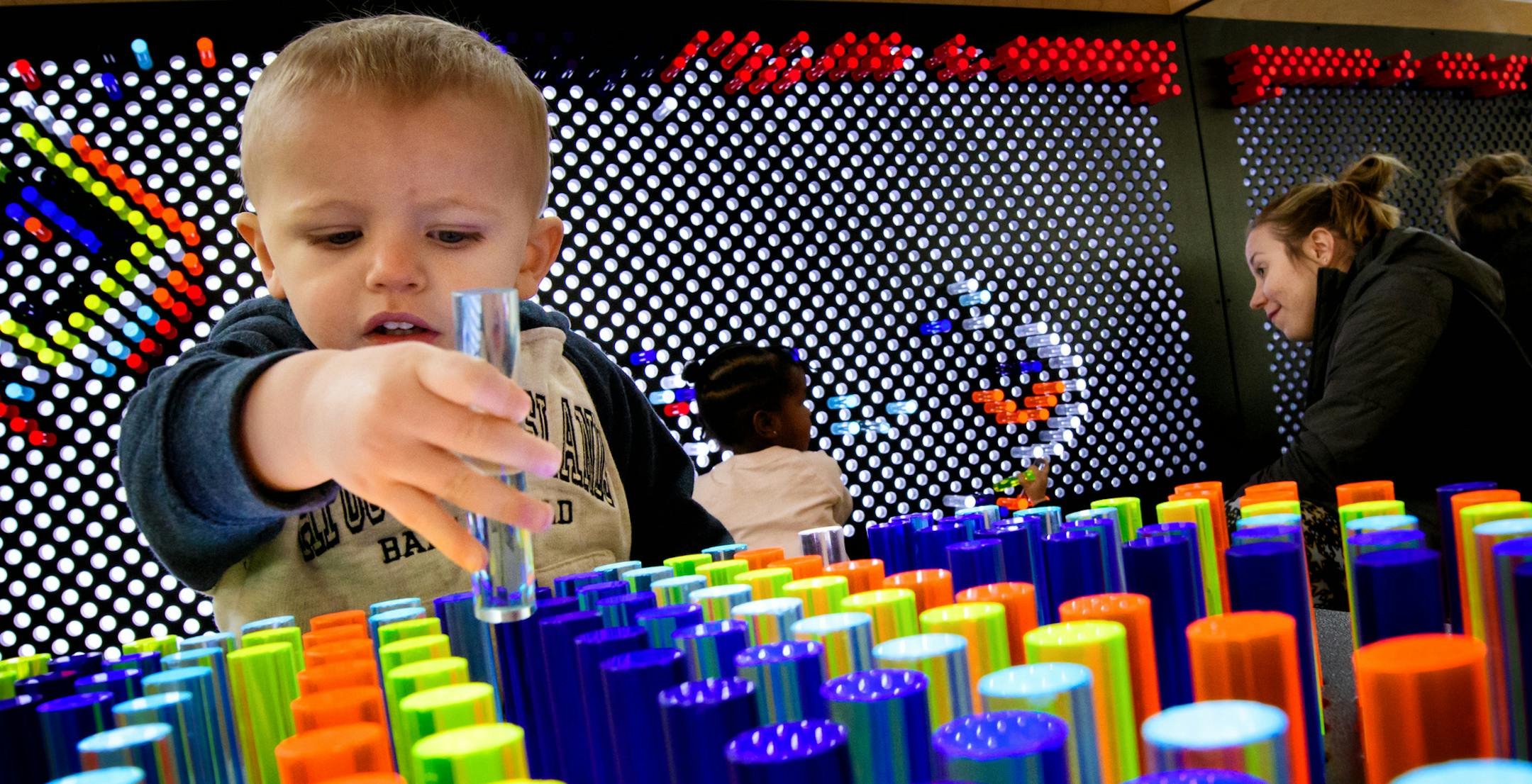 Kilik Lom, 2, played with the multicolor oversized light brite at the Brooklyn Park library. ] GLEN STUBBE * gstubbe@startribune.com Friday, January 13, 2017 The new Hennepin County library in Brooklyn Park.