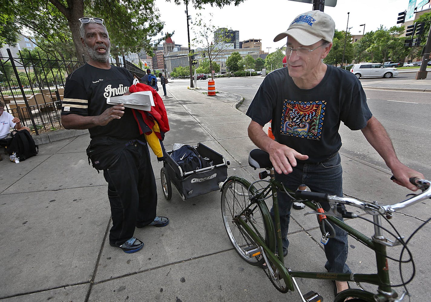 Jerry Sedgewick got back on his bicycle to continue his rounds after talking with Dwain outside the Dorothy Day Center in St. Paul.] JIM GEHRZ &#xef; james.gehrz@startribune.com / St. Paul, MN / June 118, 2015 / 9:00 AM &#xf1; BACKGROUND INFORMATION: Jerry Sedgewick sees them too, the people standing at the side of the freeway off ramps, holding signs asking for money. Sedgewick, 59 and a scientist by training, wanted to do something more meaningful that hand them a couple bucks out his car wind