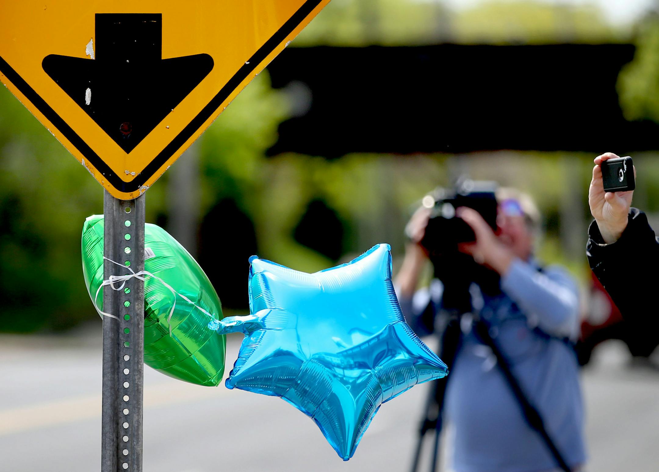 Balloons hang on a sign near the scene where a child was struck by a school bus at Maryland Ave. and Dale St. and is now in critical condition Thursday, May 5, 2016, in St. Paul, MN. Hansen said that when he got to the boy he was still conscious but clearly seriously injured.](DAVID JOLES/STARTRIBUNE)djoles@startribune.com A child is in critical condition after being struck by a school bus Thursday morning