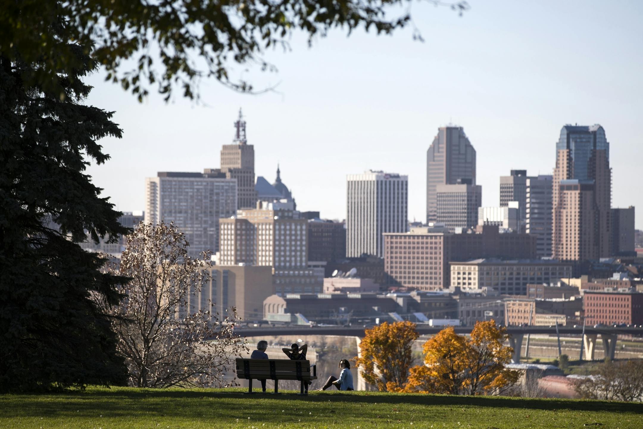 Enjoying a clear view of downtown St. Paul, Margaret Churchill, from left, Hasnaa El Hannach, and Pamela Zamora relax at Indian Mounds Park in St. Paul.