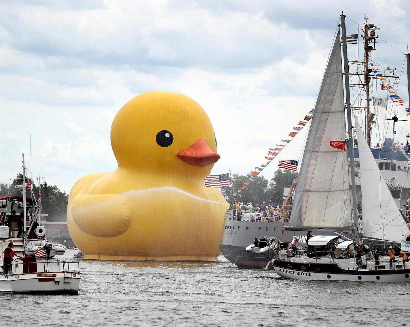 Tall Ships Duluth 2016 was back in Duluth and featured the world's largest rubber duck at 61 feet tall, about the height of a six-story building, and weighing in at 11 tons, equaling roughly 3,000 real ducks, on Aug. 18, 2016 in Duluth, Minn. The rubber duck was seen being towed past the Sundew, a retired Coast Guard Cutter with water cannons firing. (David Joles/Minneapolis Star Tribune/TNS) ORG XMIT: 1188926