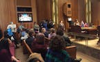 Protesters present a list of demands, related to the fatal shooting of Cordale Handy by police, at the St. Paul City Council meeting March 22.