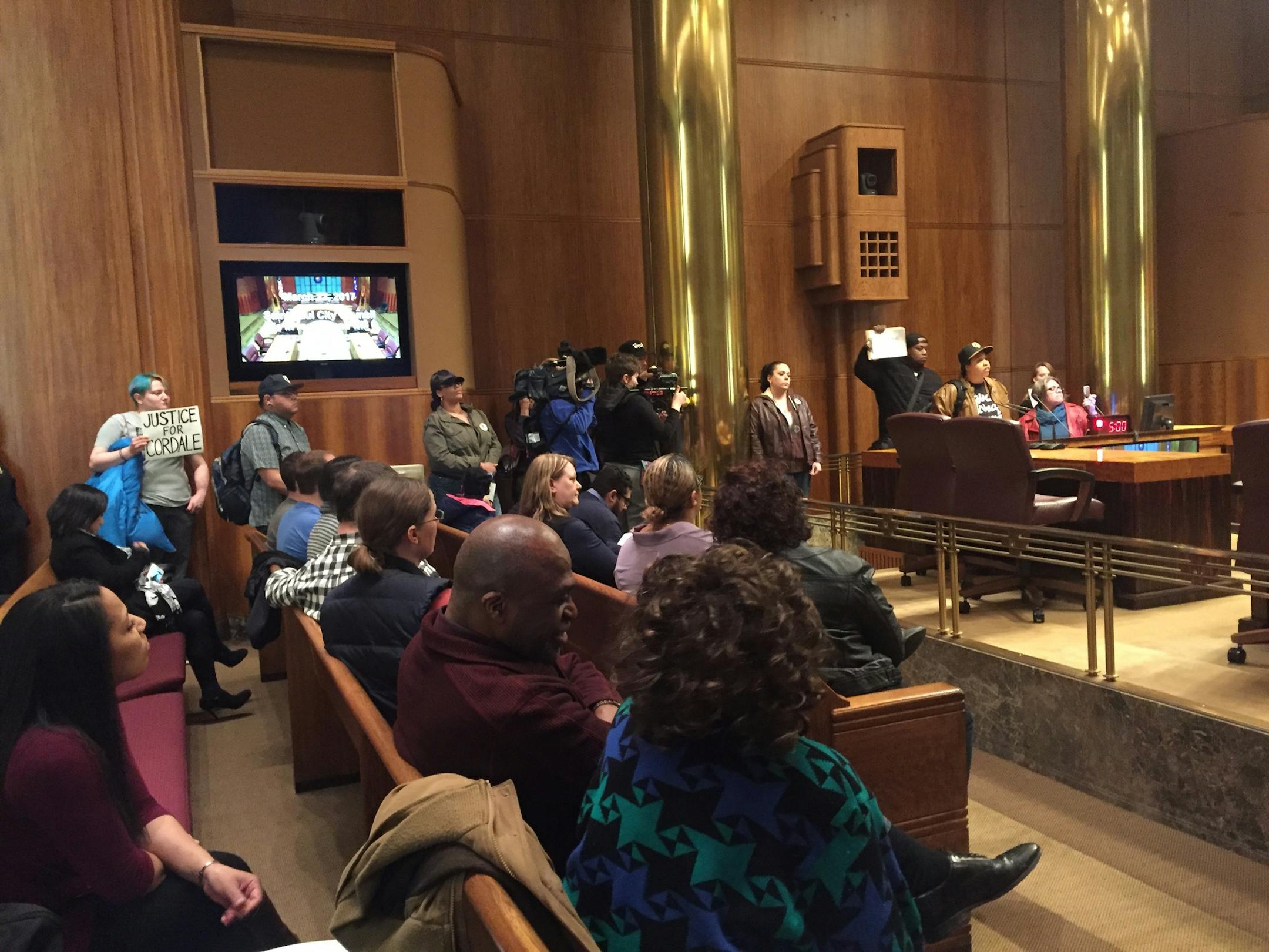 Protesters present a list of demands, related to the fatal shooting of Cordale Handy by police, at the St. Paul City Council meeting March 22.