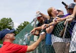 Hall of Famer Joe Mauer signs autographs Monday at the Legends of the Game Roundtable at Doubleday Field in Cooperstown, N.Y.