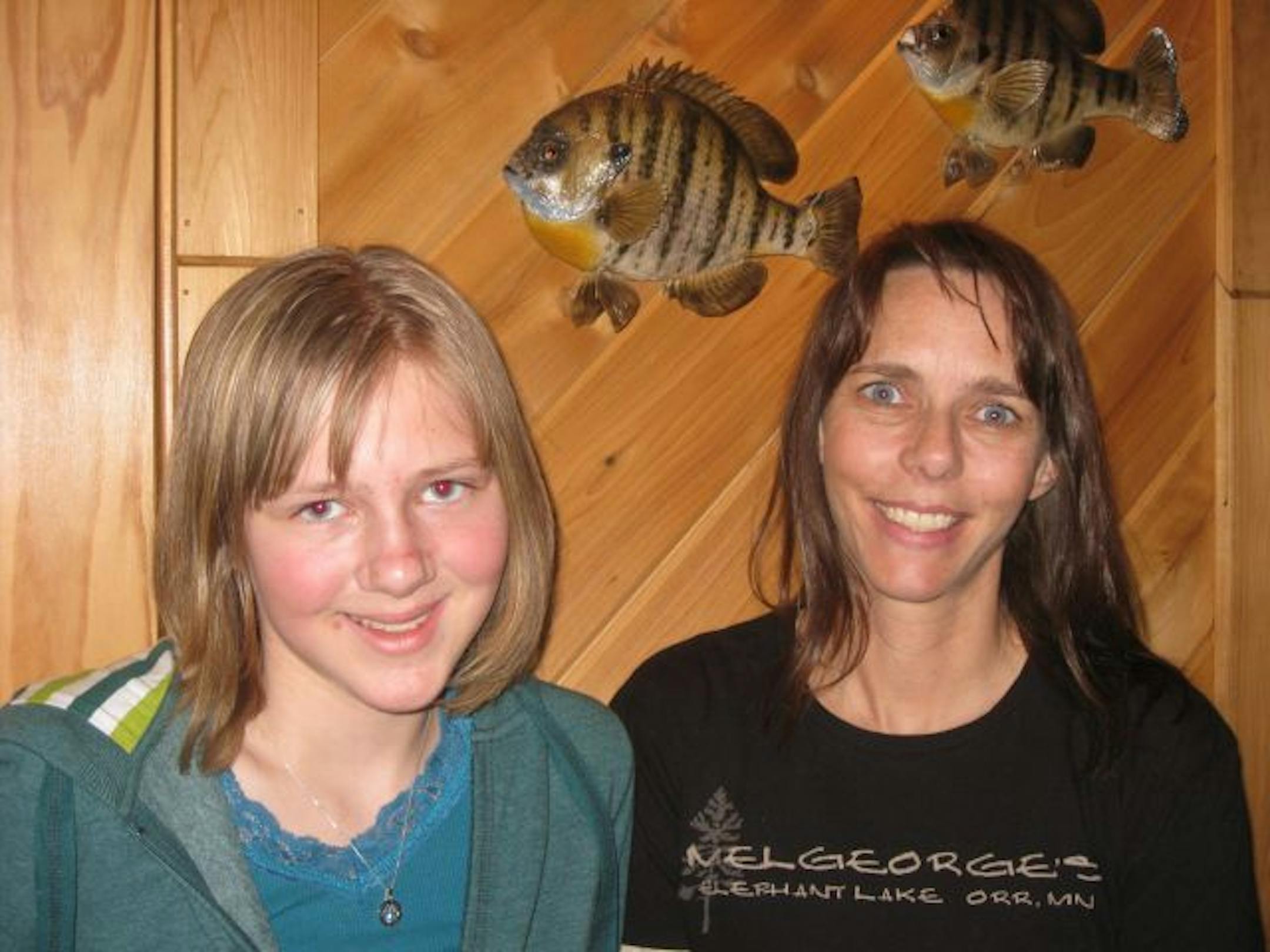 Emily Koch and her mom, Carla Koch, stand in front of the fish Carla caught with an ax, yes an ax, on Elephant Lake near Orr.