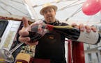 A wine storekeeper pours Beaujolais Nouveau wine in a glass during a presentation in a wine shop in Paris, Thursday Nov. 20, 2014. The wine world�s 