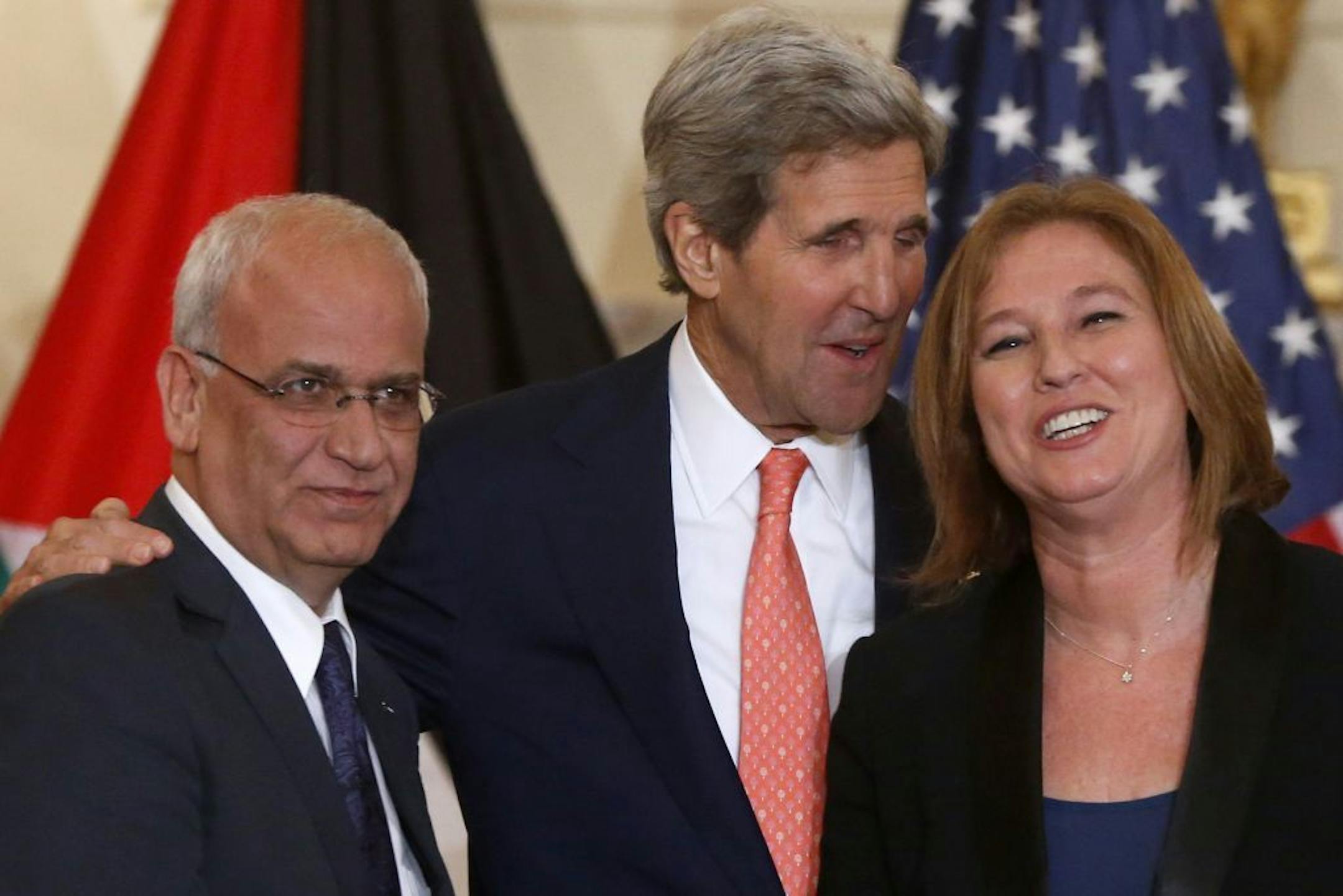Secretary of State John Kerry stands with Israel's Justice Minister and chief negotiator Tzipi Livni, right, and Palestinian chief negotiator Saeb Erekat, after they made statements on the resumption of Israeli-Palestinian peace talks, Tuesday, July 30, 2013, at the State Department in Washington.