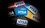 Visa Inc. credit and debit cards are arranged for a photograph in Washington, D.C., U.S., on Wednesday, Jan. 29, 2014. Visa Inc. is expected to releas