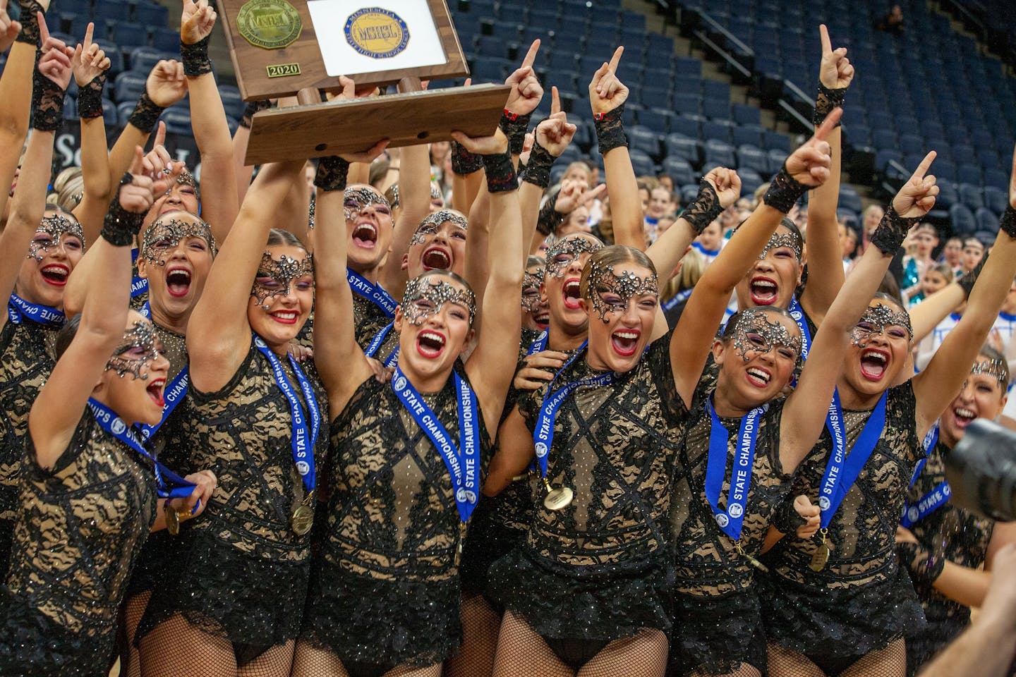 Eastview high kick dance team members celebrate after receiving their championship trophy on Feb. 15, 2020 at Target Center.