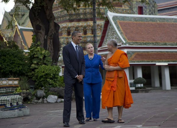 U.S. President Barack Obama, left, and U.S. Secretary of State Hillary Rodham Clinton, center, tour the Wat Pho Royal Monastery with Chaokun Suthee Th