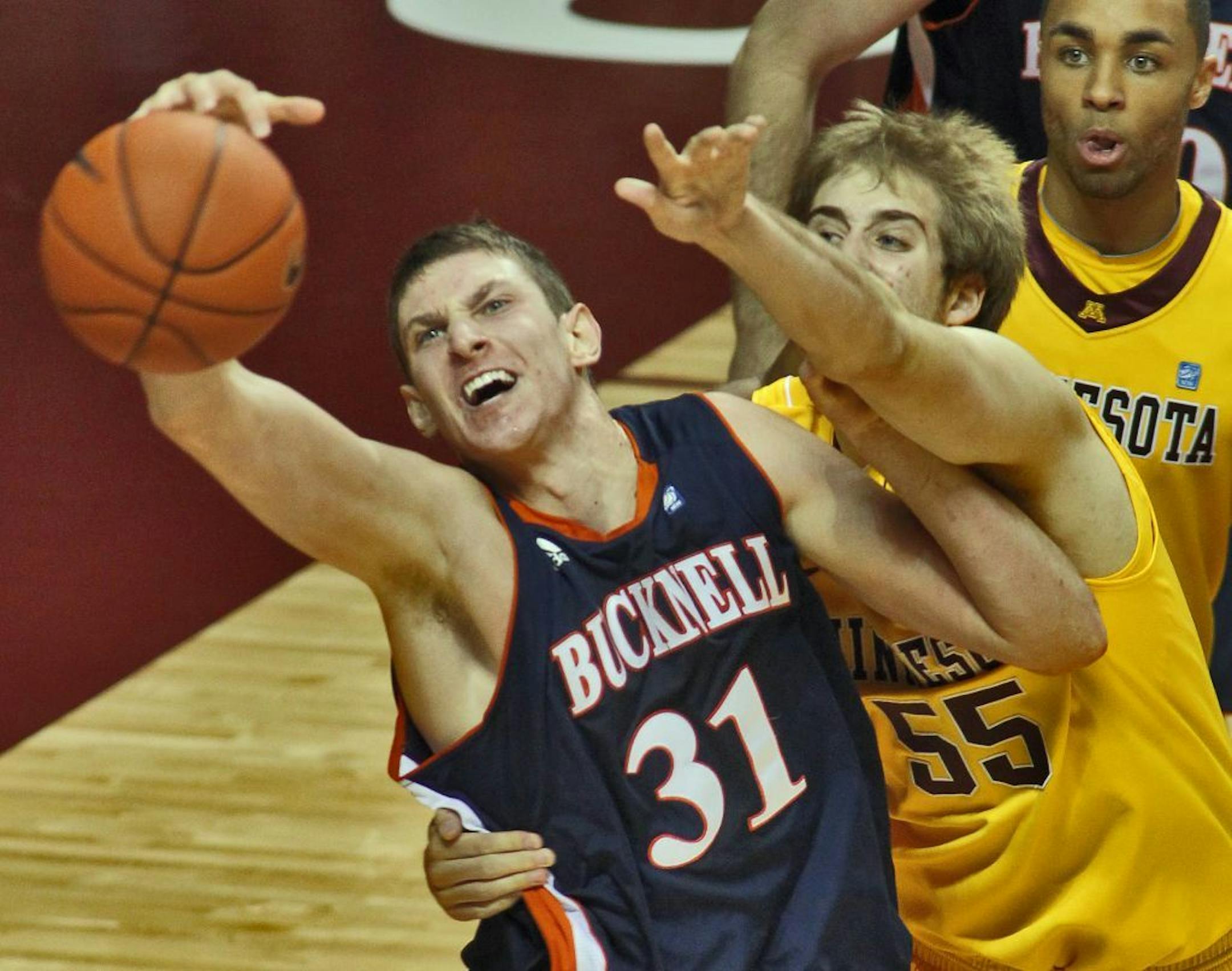 Bucknell's Mike Muscala (31) grabbed a rebound away from Gophers Elliott Eliason (55) earlier this season.