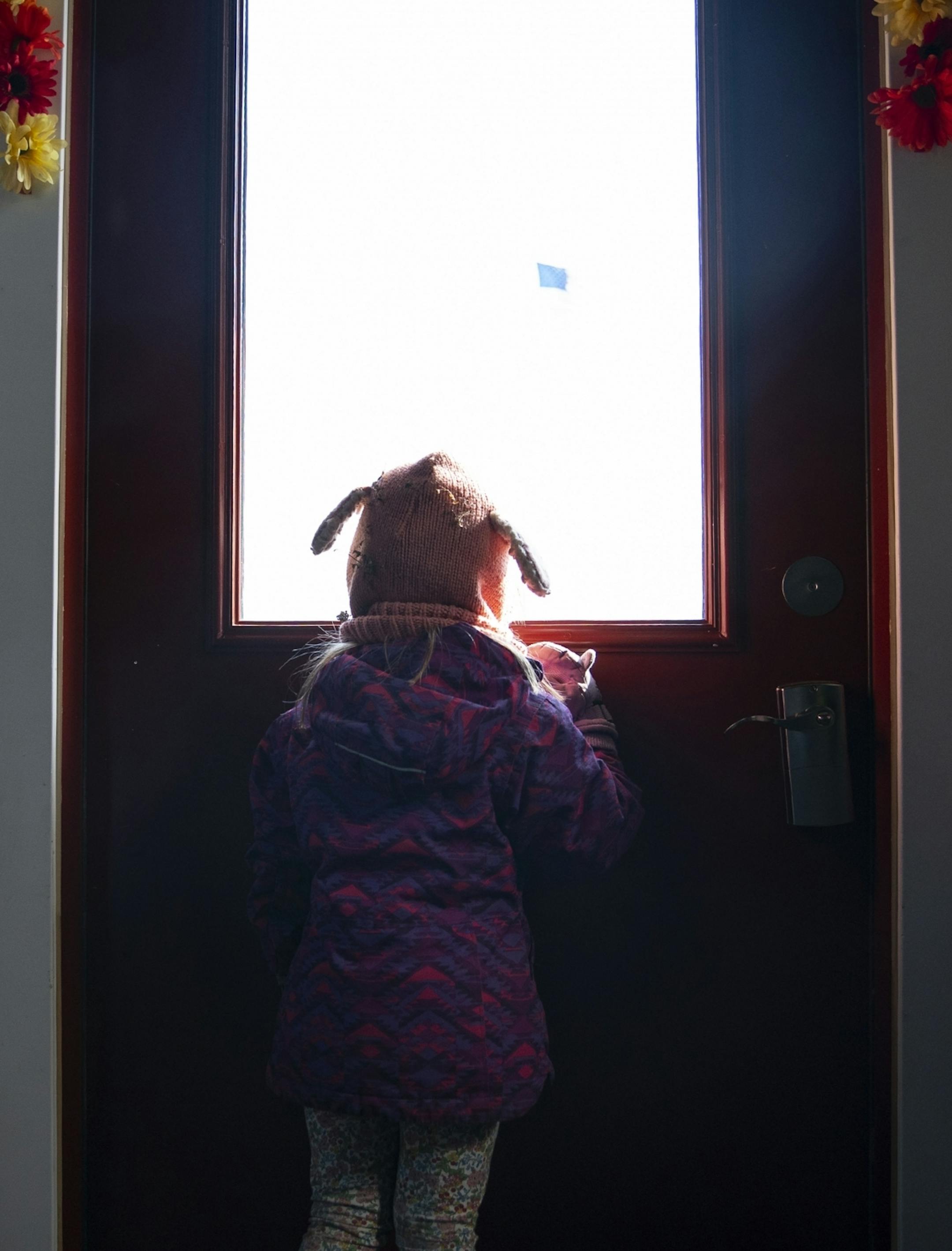 Nola looked out the window as she waited for the okay to go outside for playtime at Aunty's Child Care in Duluth, MN on Thursday.