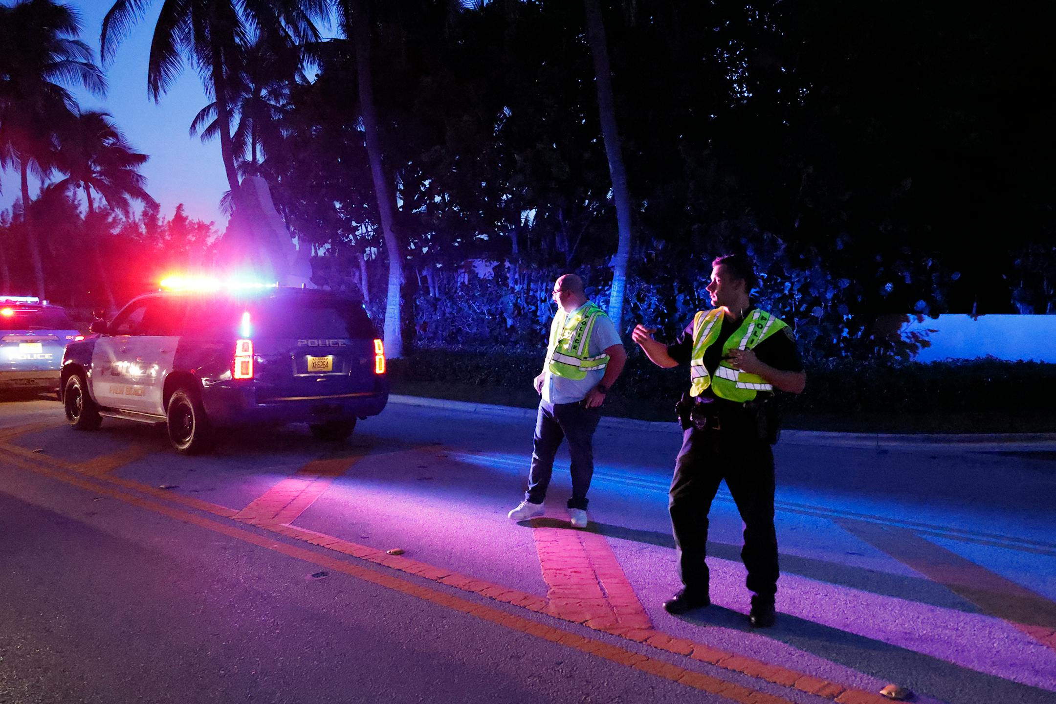 Police direct traffic outside an entrance to former President Donald Trump's Mar-a-Lago estate, Monday, Aug. 8, 2022, in Palm Beach, Fla.