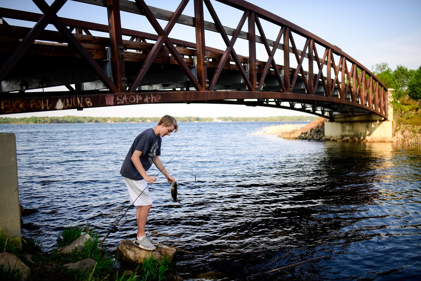 Anthony Brooks, a freshman at White Bear High School's north campus, released a largemouth bass he caught on White Bear Lake recently.