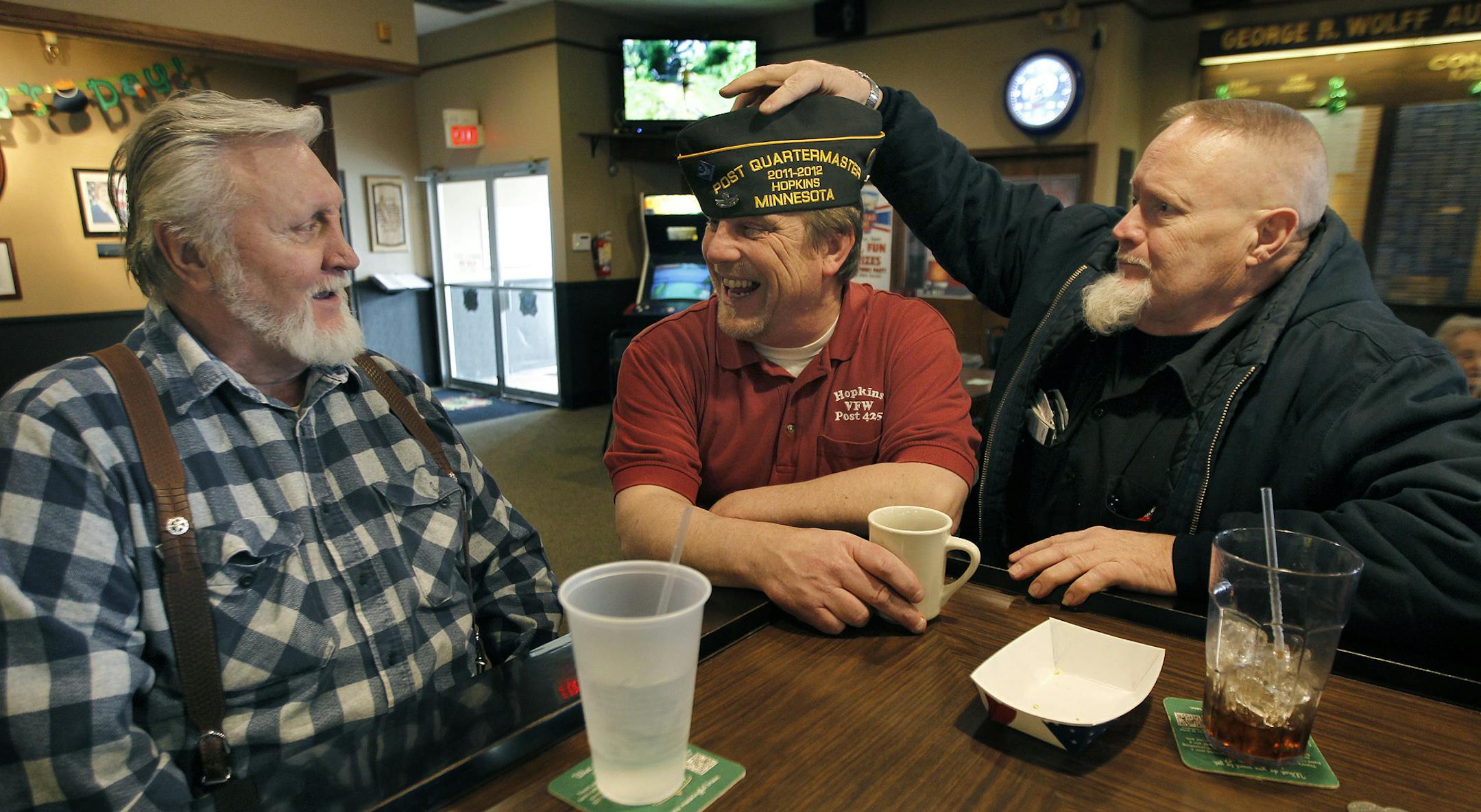 VFW member Tommy Johnson, center, talked and laughed with friends Ken Nordstrom, left, and Lon Rogness, the Post Chaplain, at the Hopkins VFW, Wednesday, March 19, 2014 in Hopkins, MN. ] (ELIZABETH FLORES/STAR TRIBUNE) ELIZABETH FLORES • eflores@startribune.com