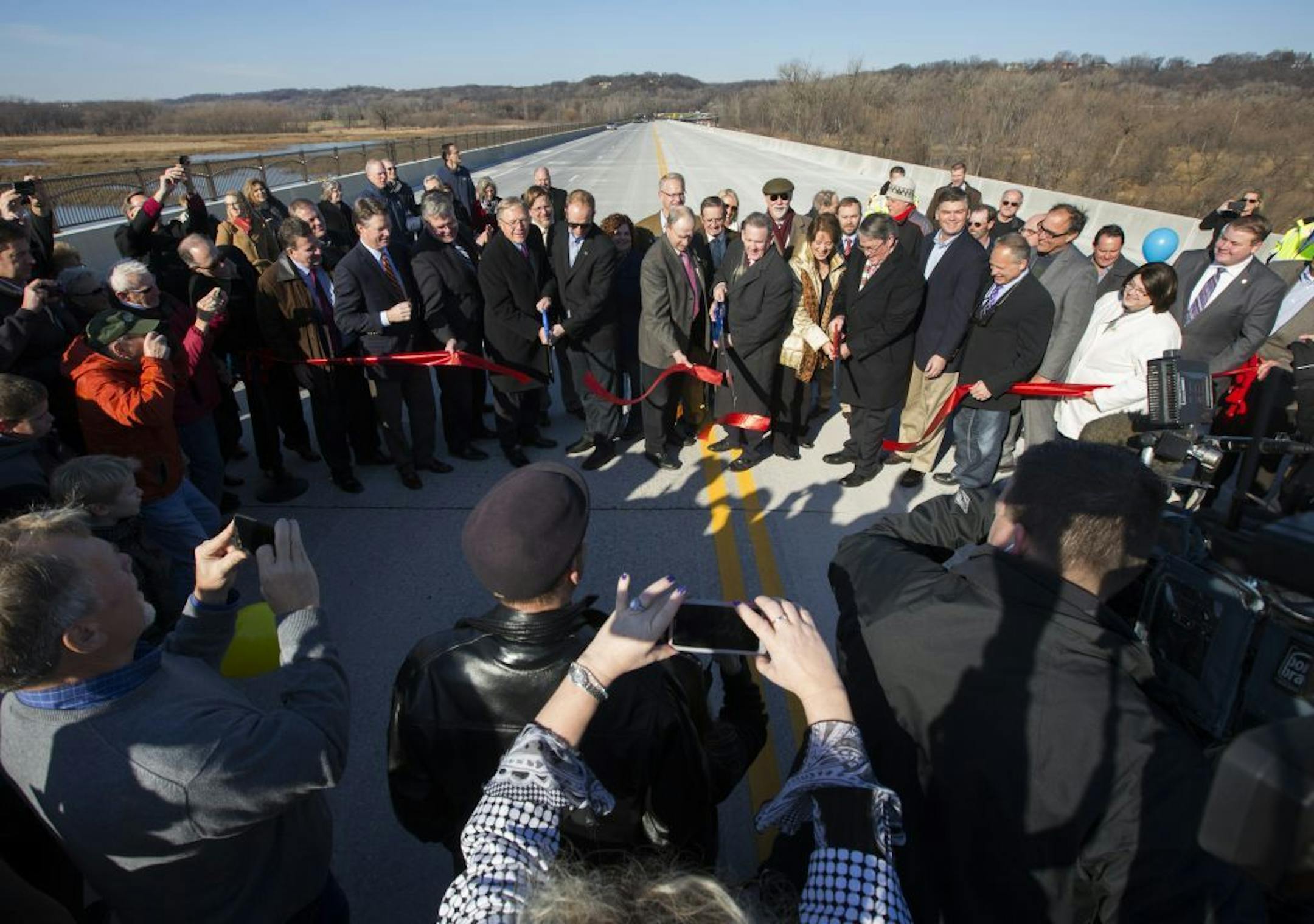 Dozens of residents and leaders from Scott and Carver counties celebrated the opening of the new County Road 101 bridge Tuesday morning, walking from opposite ends of the 4,100-foot river crossing for a ceremonial ribbon cutting in the middle.