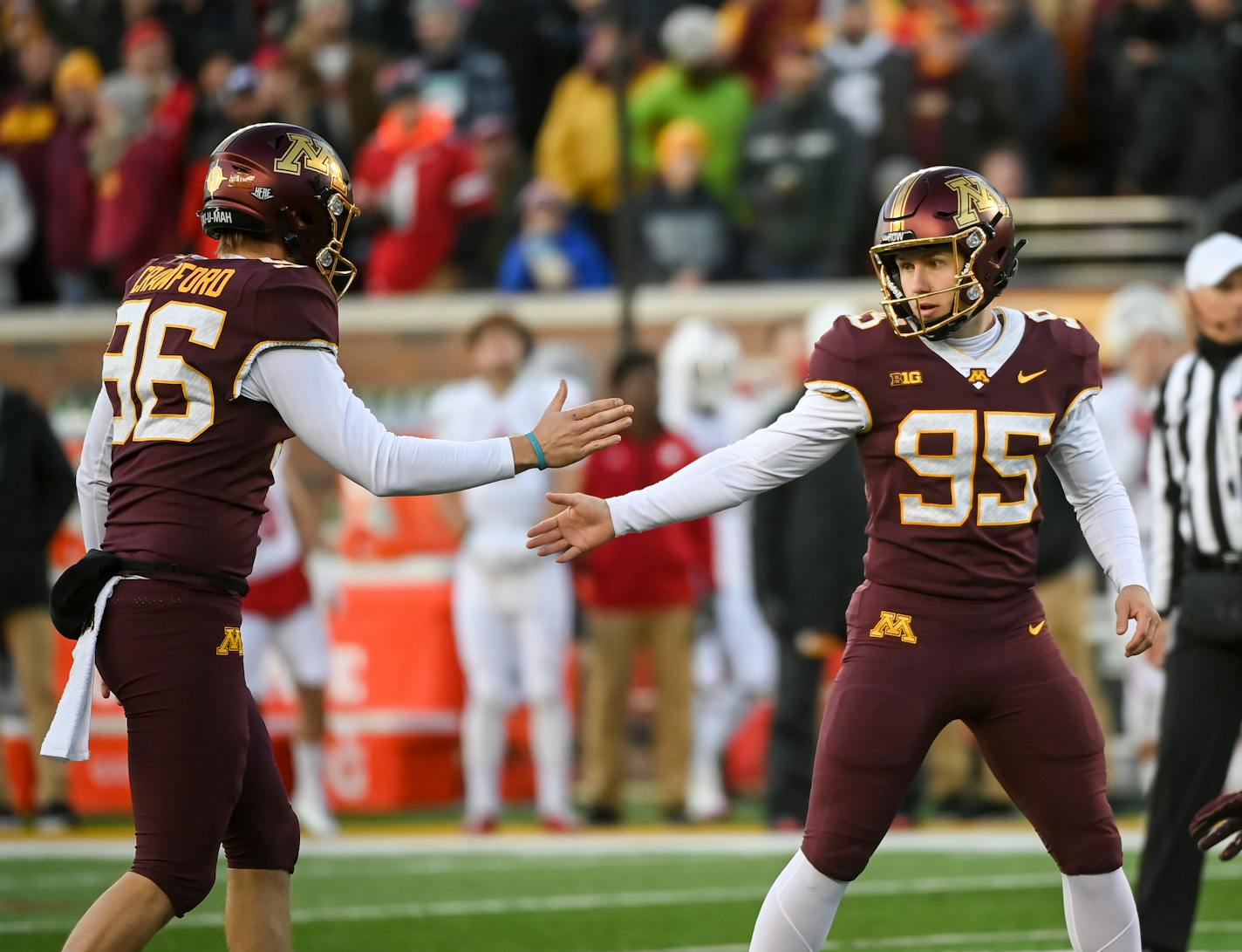 Minnesota Gophers kicker Mark Crawford (96) and place kicker Matthew Trickett (95) celebrate a field goal by Trickett during the second quarter of an NCAA football game between the Minnesota Gophers and the Wisconsin Badgers Saturday, Nov. 27, 2021 at Huntington Bank Stadium in Minneapolis, Minn. ] AARON LAVINSKY • aaron.lavinsky@startribune.com