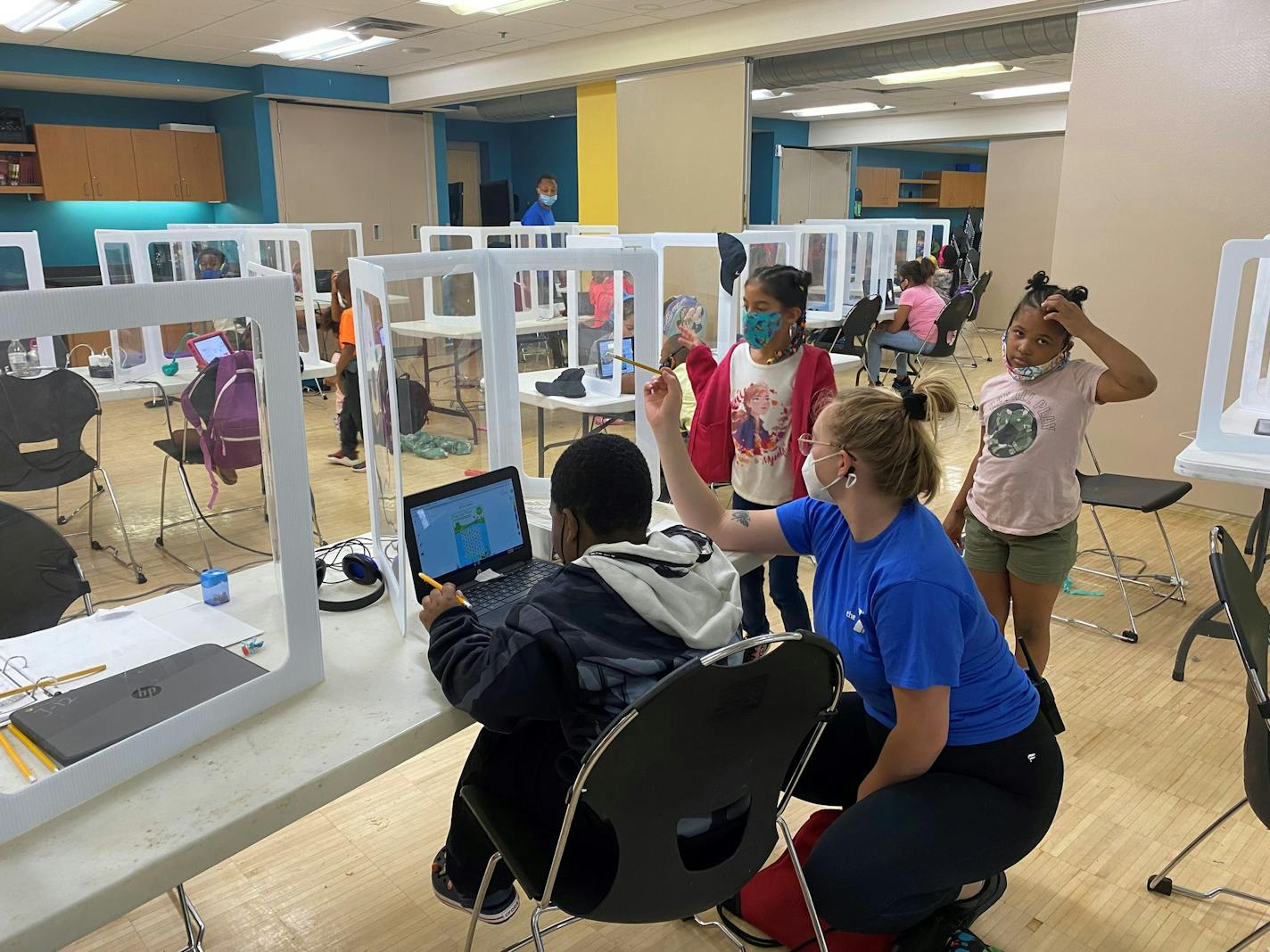 Students do school work at learning pods in a pilot program at Harold Mezile North Community YMCA in Minneapolis on Sept. 22, 2020.