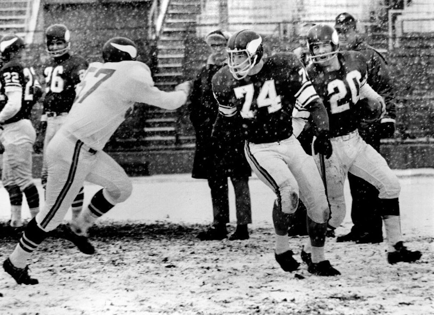 December 5, 1963 The Indomitable Snowmen -- The Vikings installed their December offense at Midway Stadium Wednesday, this time without the help of plows and shovels. Tommy Mason glides through the snowflakes behind Dave O'Brien. The defensive player is linebacker Bill Jobko. December 4, 1963 John Croft, Minneapolis Star Tribune