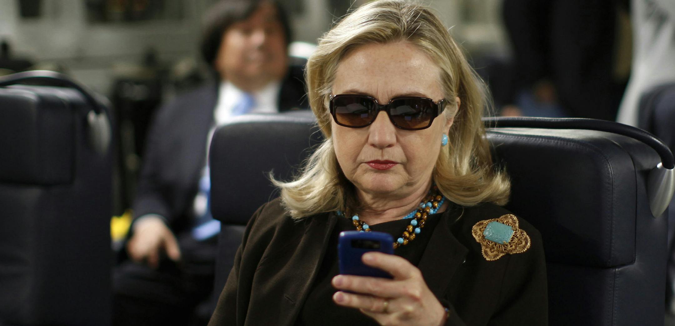 FILE - In this Oct. 18, 2011, file photo, then-Secretary of State Hillary Rodham Clinton checks her Blackberry from a desk inside a C-17 military plane upon her departure from Malta, in the Mediterranean Sea, bound for Tripoli, Libya. The Obama administration is confirming, Friday, Jan. 29, 2016, for the first time that Hillary Clinton's unsecured home server contained some closely guarded secrets, including material requiring one of the highest levels of classification. (Kevin Lamarque/Pool Pho