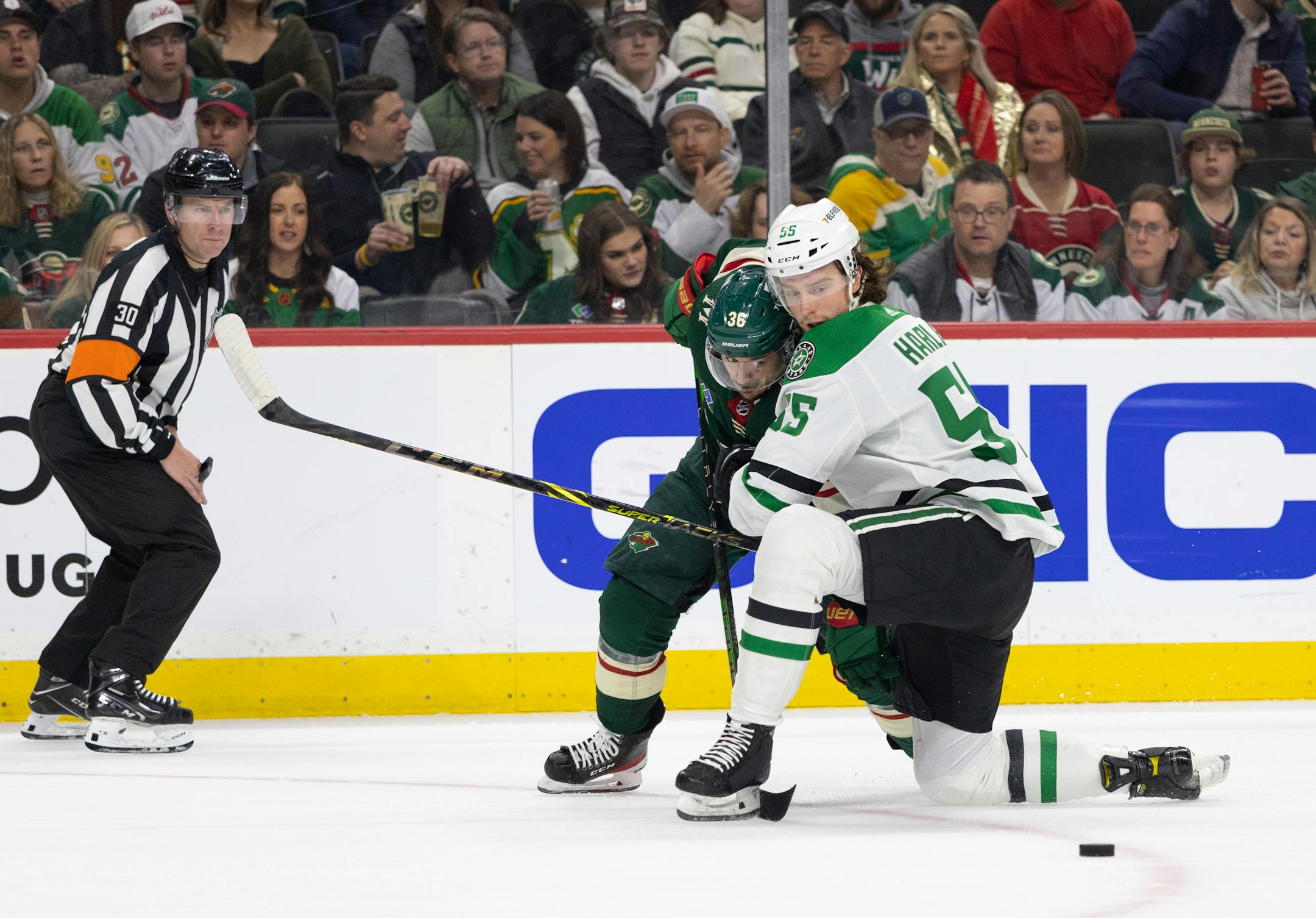 Minnesota Wild right wing Mats Zuccarello (36) and Dallas Stars defenseman Thomas Harley (55) watched the puck slide away from them in the first period. The Minnesota Wild faced the Dallas Stars in Game 6 of an NHL hockey Stanley Cup first-round playoff series, Friday night at Xcel Energy Center in St. Paul.