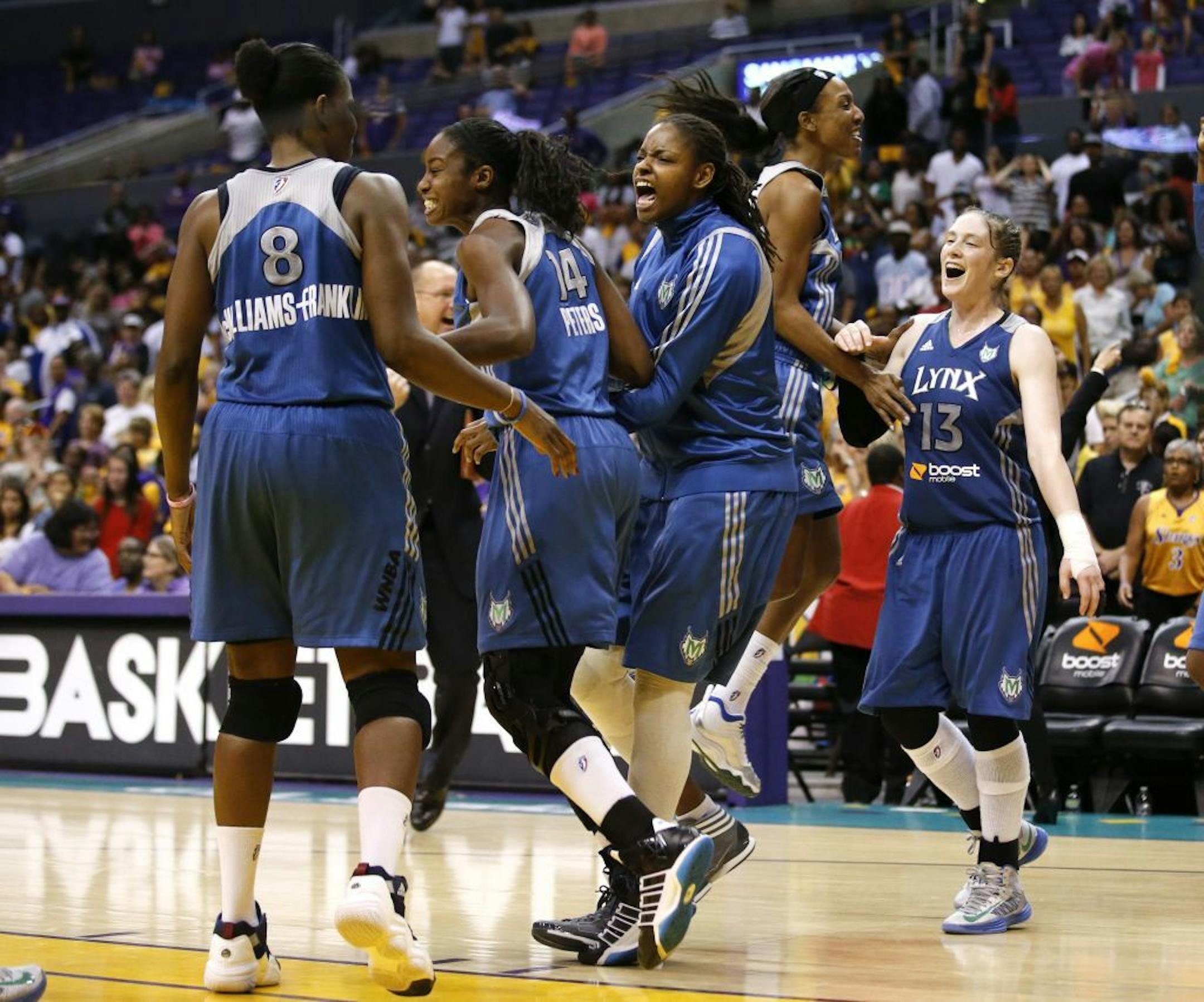Lynx players celebrate their team's 80-79 win after Game 2 of the WNBA basketball Western Conference Finals against the Los Angeles Sparks.