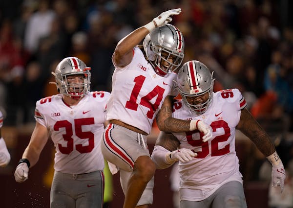 Ohio State defensive tackle Haskell Garrett (92) was congratulated by Buckeyes safety Ronnie Hickman after he recovered a fumble in the third quarter.