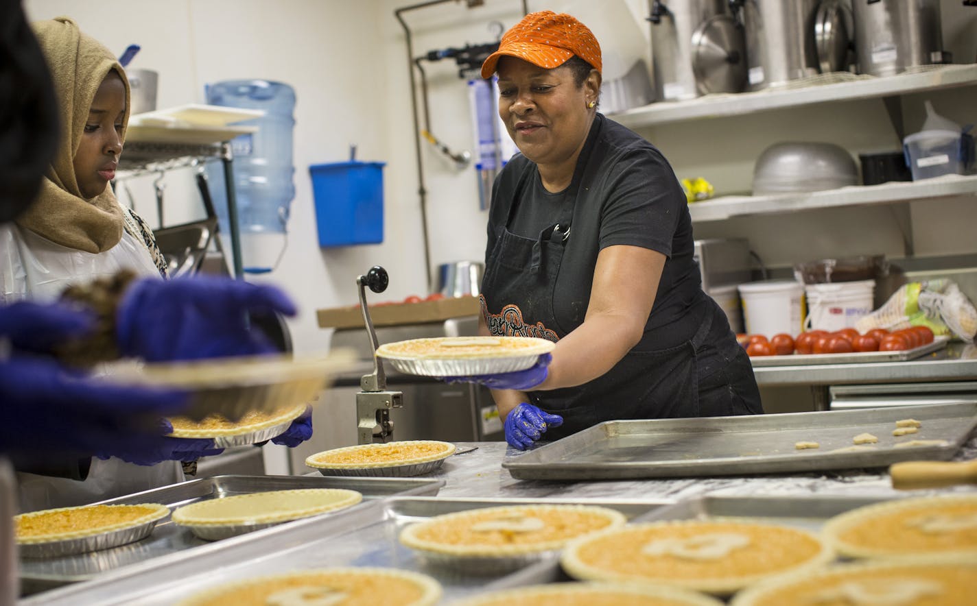 Rose McGee handled a sweet potato pie to be put in the oven to volunteer at Calvery Lutheran Church on Monday, August 10, 2015 in Golden Valley, Minn. Golden Valley resident Rose McGee and her friends baked 86 "sweet potato comfort pies" that will shipped to Mother Emanuel AME Church to be handed out at the Wednesday night Bible study where the shooting took place. The number 86 was chosen because Rev. Martin Luther King Jr. would be 86 this year. ] RENEE JONES SCHNEIDER &#x2022; reneejones@star