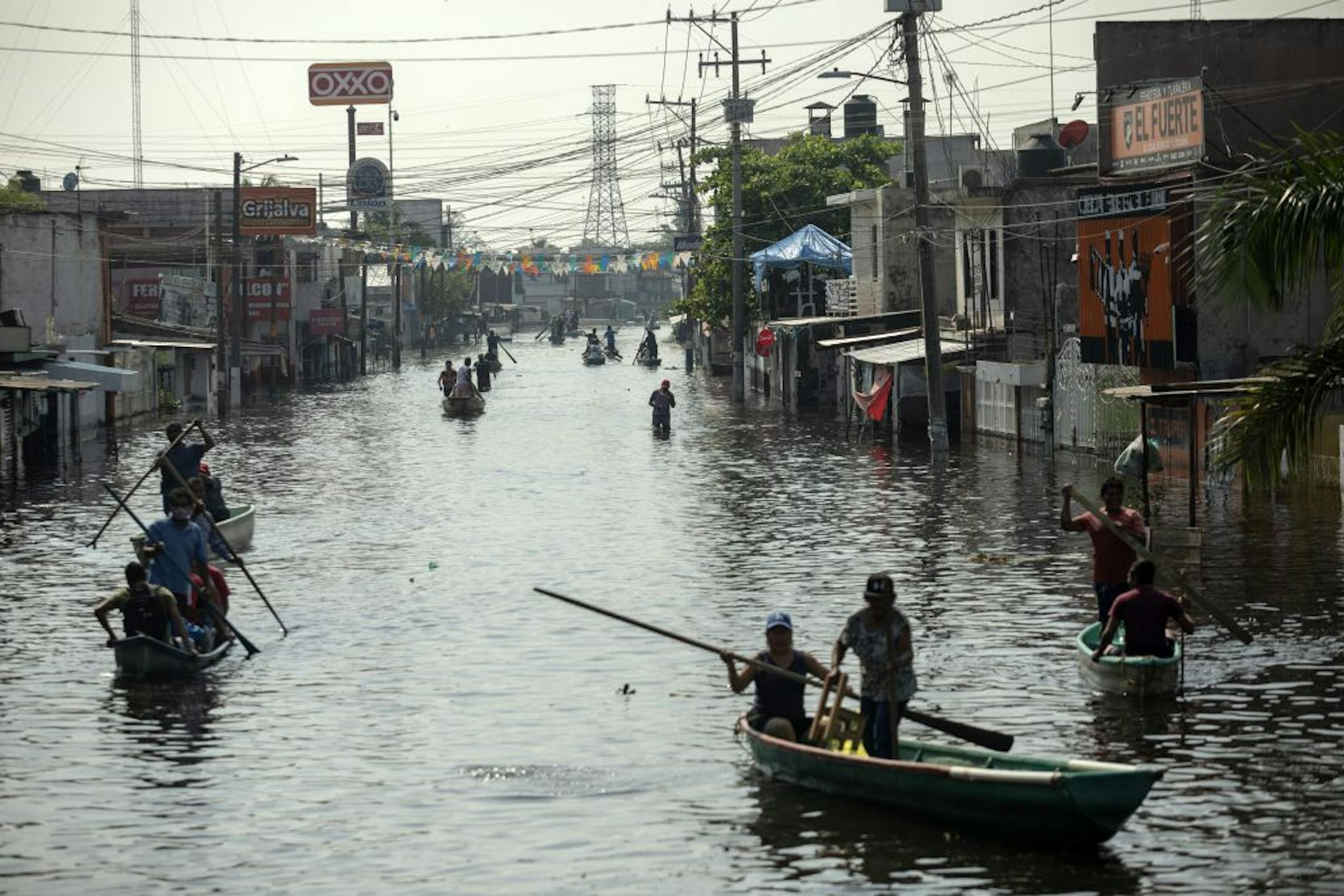 Residents uses boats to navigate the flooded streets in Villahermosa, Mexico, Wednesday, Nov. 11, 2020. Flooding has affected thousands in the Gulf coast state of Tabasco. The native state of Mexico's President Andrés Manuel López Obrador has been under water for days, sending nearly 10,000 people to shelters.