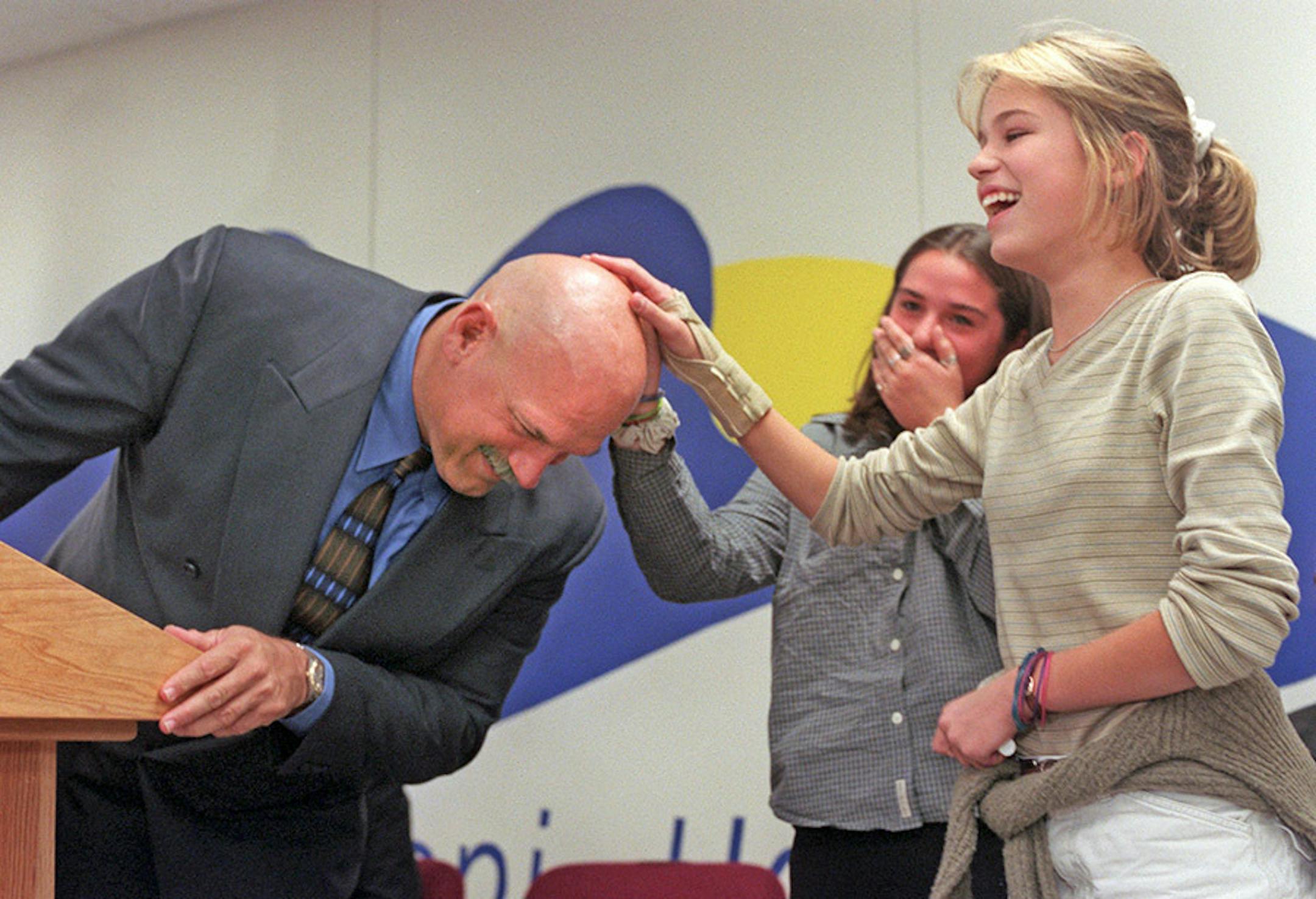 Brainerd, MN. October 19, 1999. Gov. Jesse Ventura travels to the Brainerd area to announce the third part of his ``Big Plan'' for the state. -- The final question for Governor Jesse Ventura during his visit to Mississippi Horizons Middle School in Brainerd was by Jill Teufert and Allison Snider (left and right)--he gladly accommodated their request to rub his head.