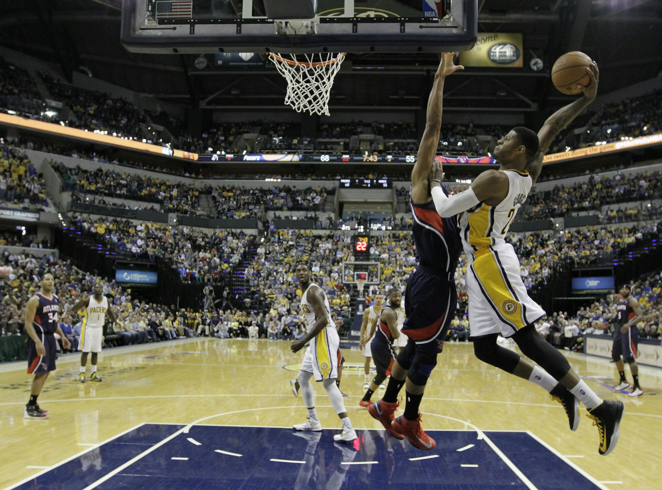 Indiana Pacers' Paul George (24) goes up for a dunk against Atlanta Hawks' Al Horford during the second half of Game 1 in the first round of the NBA basketball playoffs on Sunday, April 21, 2013, in Indianapolis. Indiana defeated Atlanta 107-90. (AP Photo/Darron Cummings)