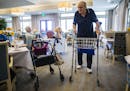 Bob Stiegler, 88, greets other residents in the dining room after eating lunch on September 5, 2018, at The Village at Mapleshade in Plano, Texas. His