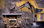 GLEN STUBBE &#x221a;&#xd8; gstubbe@startribune.com MONDAY, October 2, 2006 -- Eveleth, Minn. -- A hydraulic shovel scrapes up 50 tons at a time of tac