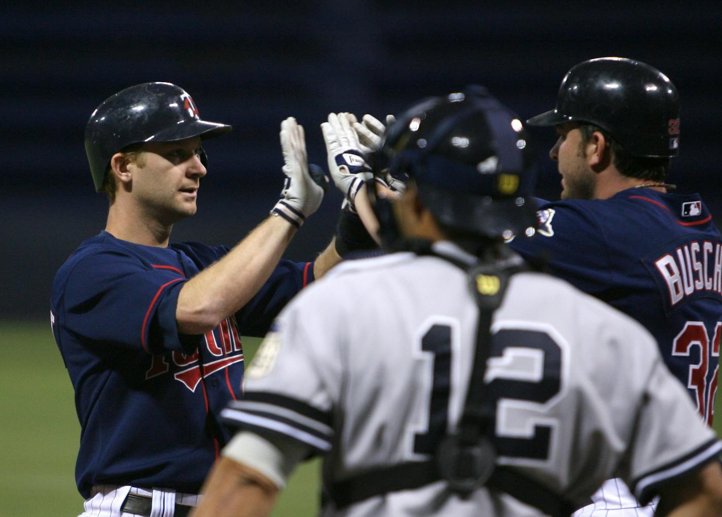 Adam Everett was congratulated at the plate by Brian Buscher after both scored on Everett's two-run homer Monday. Yankees catcher Ivan Rodriguez watched.