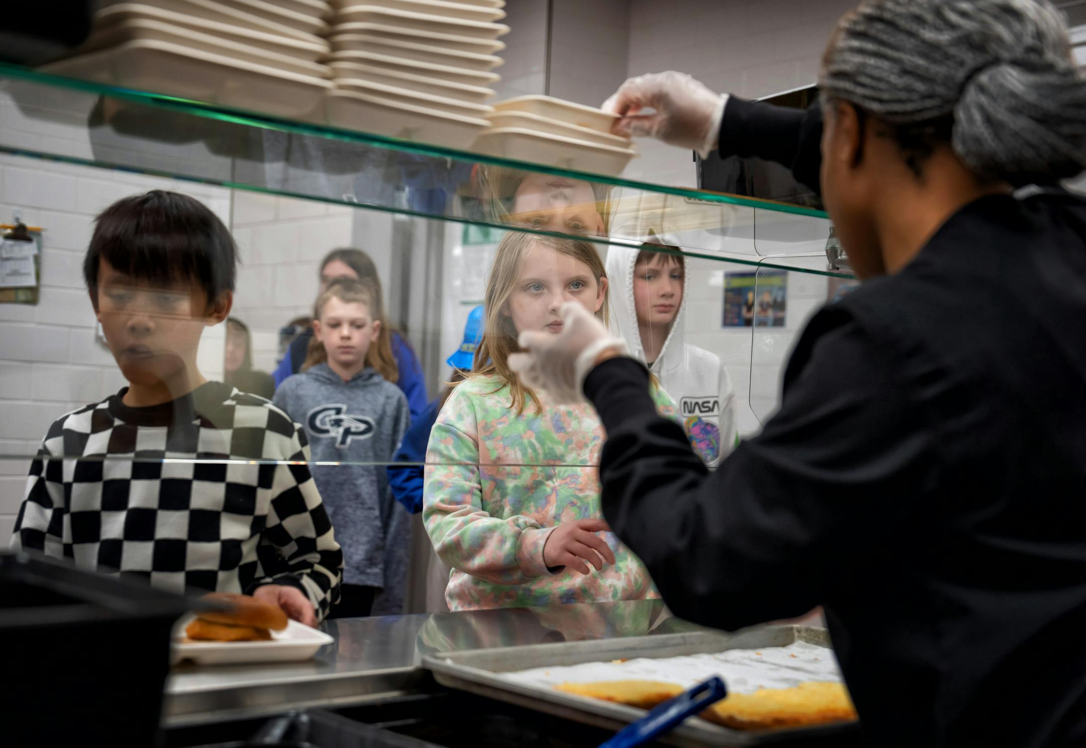Cassandra Day served school lunch to 5th graders at Champlin-Brooklyn Park Academy on Friday, Feb. 17, 2023 in Champlin, Minn.