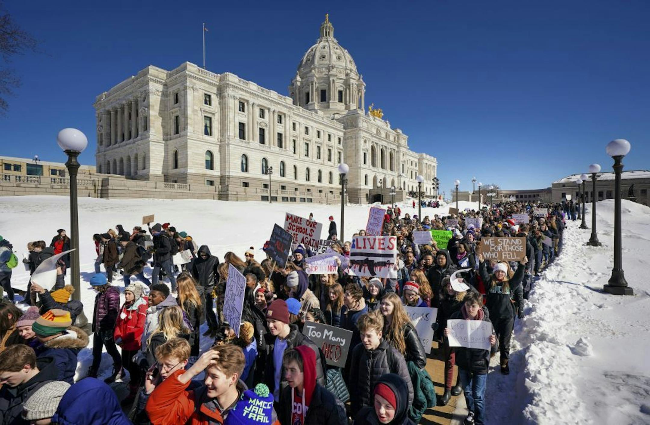 Thousands of high school students march to the state Capitol in Saint Paul, Minn., after they walked out of their schools Wednesday, March 7, 2018, to protest gun violence and pressure lawmakers to enact stricter gun control.