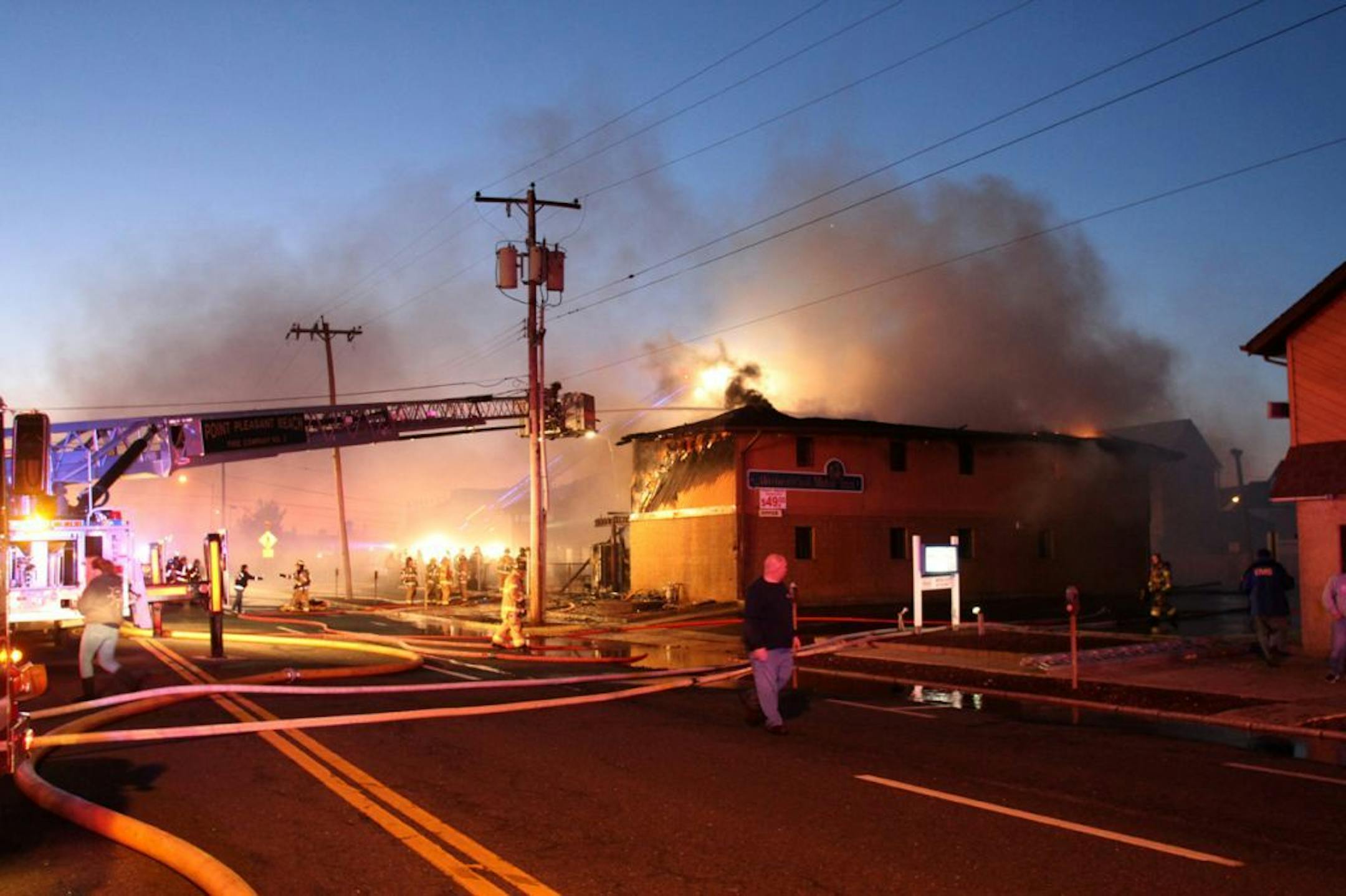 Firefighters work to put out a fire at Mariner's Cove Inn in Point Pleasant Beach, N.J. early Friday, March 21, 2014.