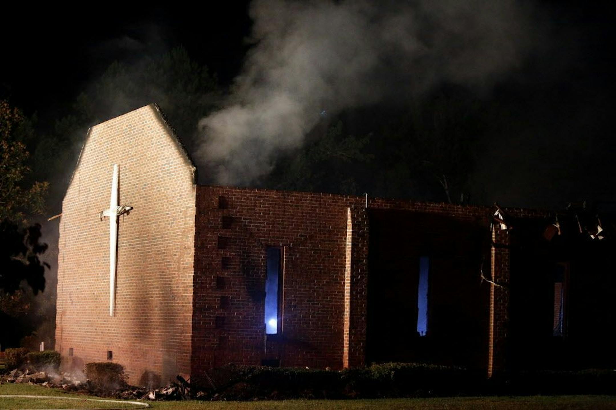 Smoke rises from Mount Zion African Methodist Episcopal church late Tuesday, June 30, 2015, in Greeleyville, S.C., which caught fire Tuesday. The African-American church that was burned down by the Ku Klux Klan in 1995 caught fire again Tuesday night.