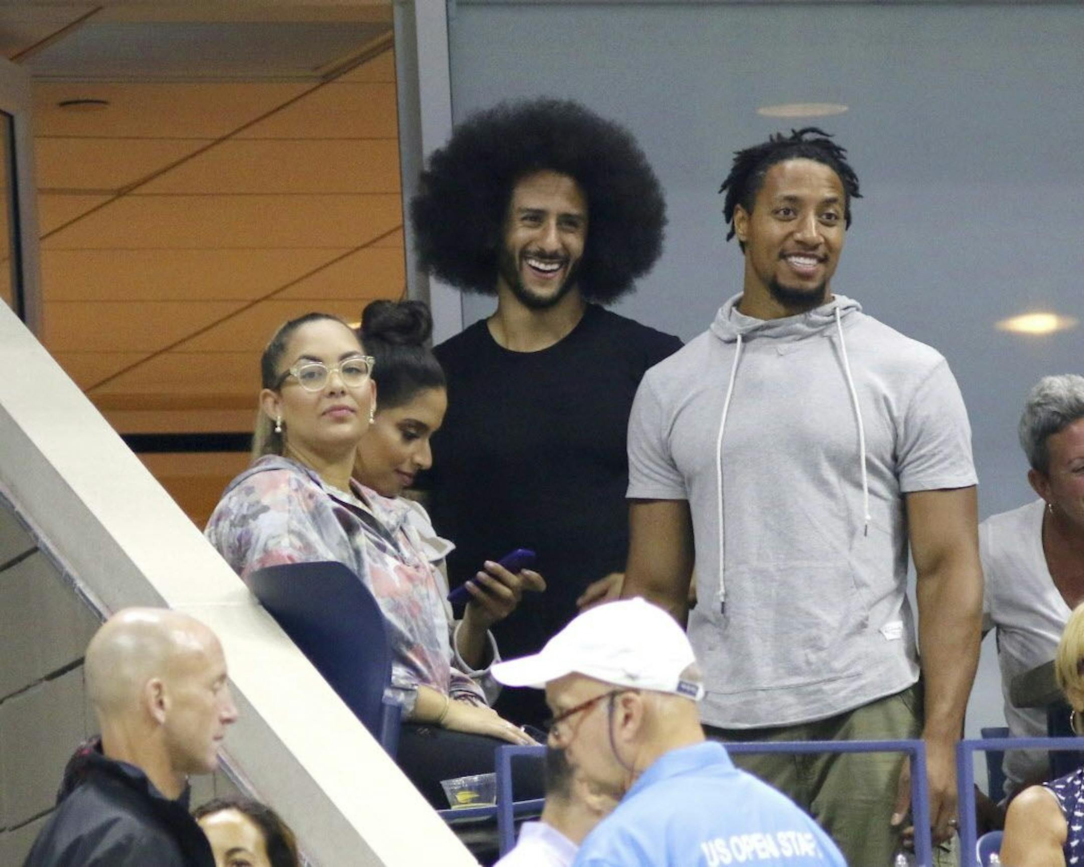 Colin Kaepernick, center, attends the third round of the U.S. Open tennis tournament at the USTA Billie Jean King National Tennis Center on Friday, Aug. 31, 2018, in New York.