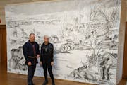Sámi artist Tomas Colbengtson & Swedish artist Stina Folkebrant stand in front of Folkebrant's drawing of reindeer at the American Swedish Institute.