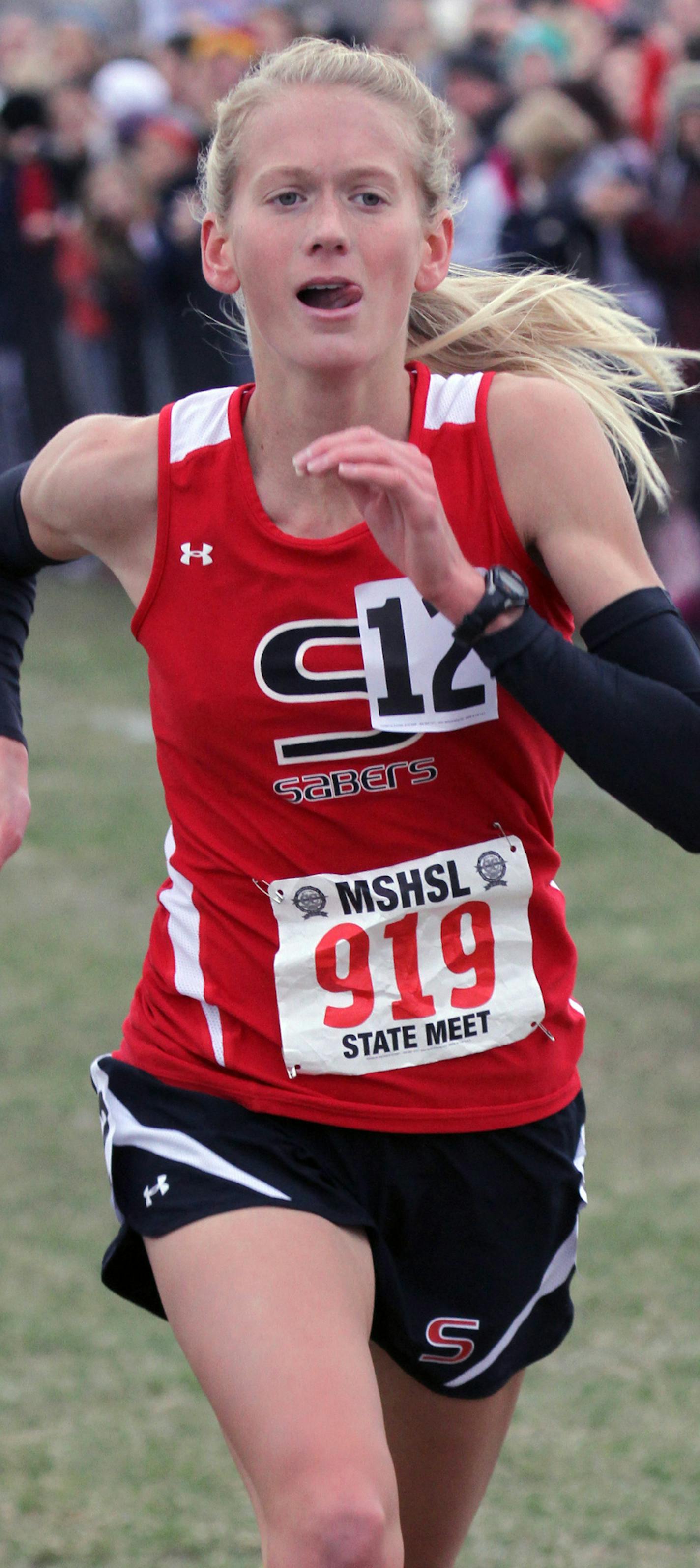 Minnesota Boys and Girls Cross Country State Meet, St. Olaf College, Northfield MN., 11/3/12. (center) Maria Hauger of Shakopee sprinted to the finish line to win the Class AA Girls 4000 meter race .] Bruce Bisping/Star Tribune bbisping@startribune.com Maria Hauger/program. ORG XMIT: MIN1211031527215967