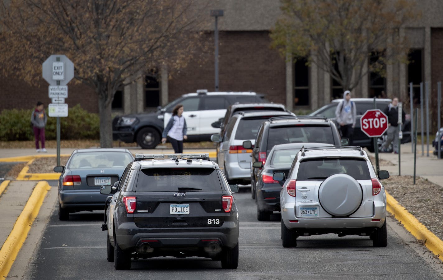 A police vehicle pulled up to Bloomington Jefferson High School while cars waited to pick students. (Carlos Gonzalez/Minneapolis Star Tribune/TNS) ORG XMIT: 1481150