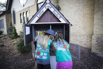 Girl scouts Justine Meyers and Zoey Myers stocked up a free little pantry on Tuesday, August 29, 2017, in Chaska, Minn. ] RENEE JONES SCHNEIDER &#xef;