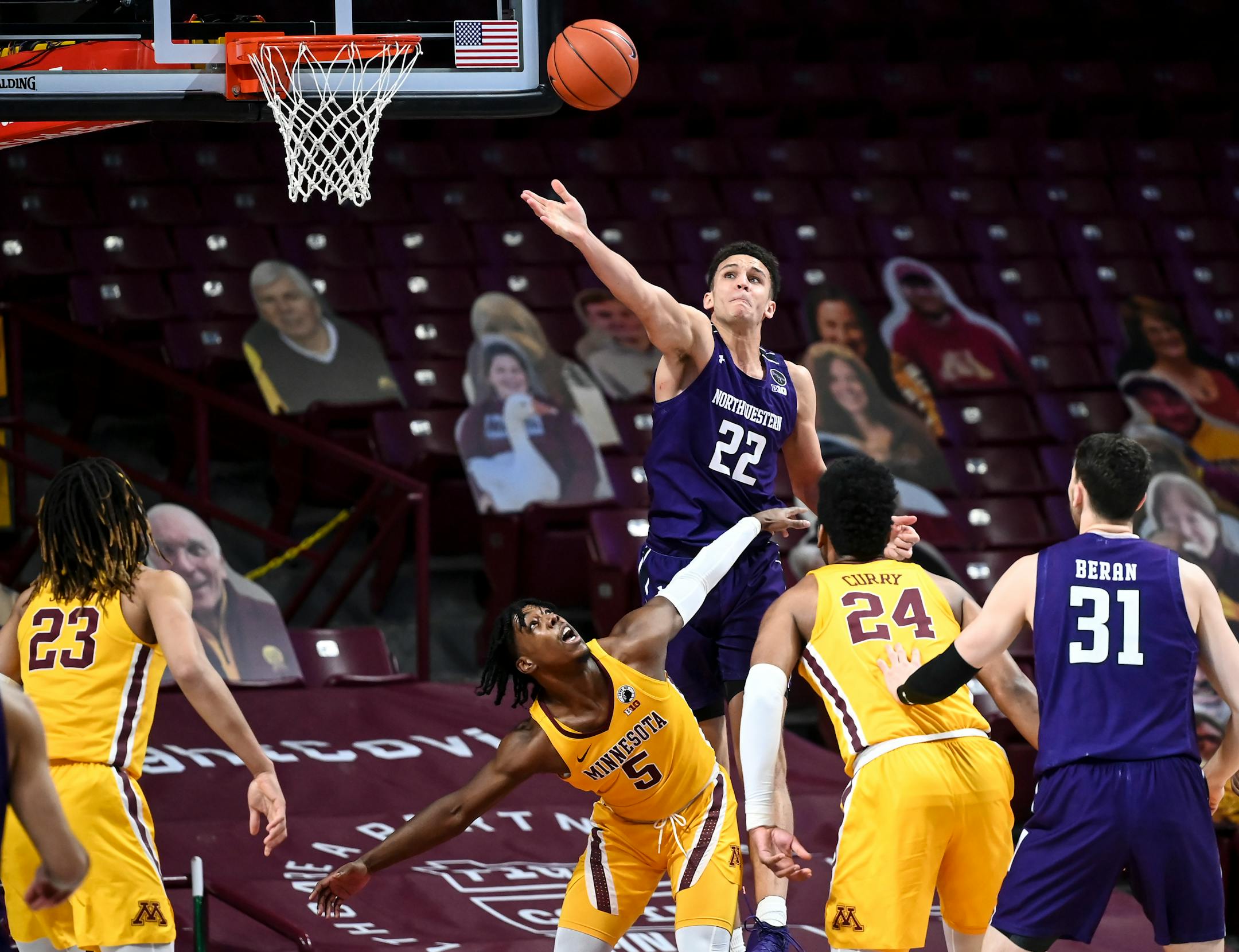 Minnesota Gophers guard Marcus Carr (5) and Northwestern Wildcats forward Pete Nance (22) battled for a rebound in the first half.