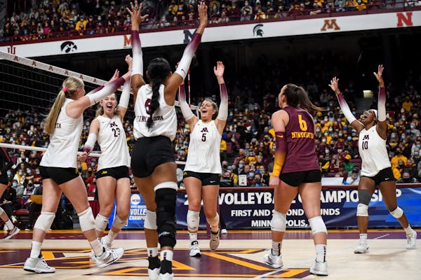 The Minnesota Gophers celebrate a point scored against Stanford during the first set Saturday, Dec. 4, 2021 at Maturi Pavilion in Minneapolis, Minn. T