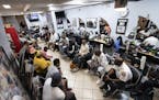 Philadelphia Police and residents gather during a meeting called "Blades, Fades, and Engage" at the Philly Cuts barbershop in Philadelphia on Septembe