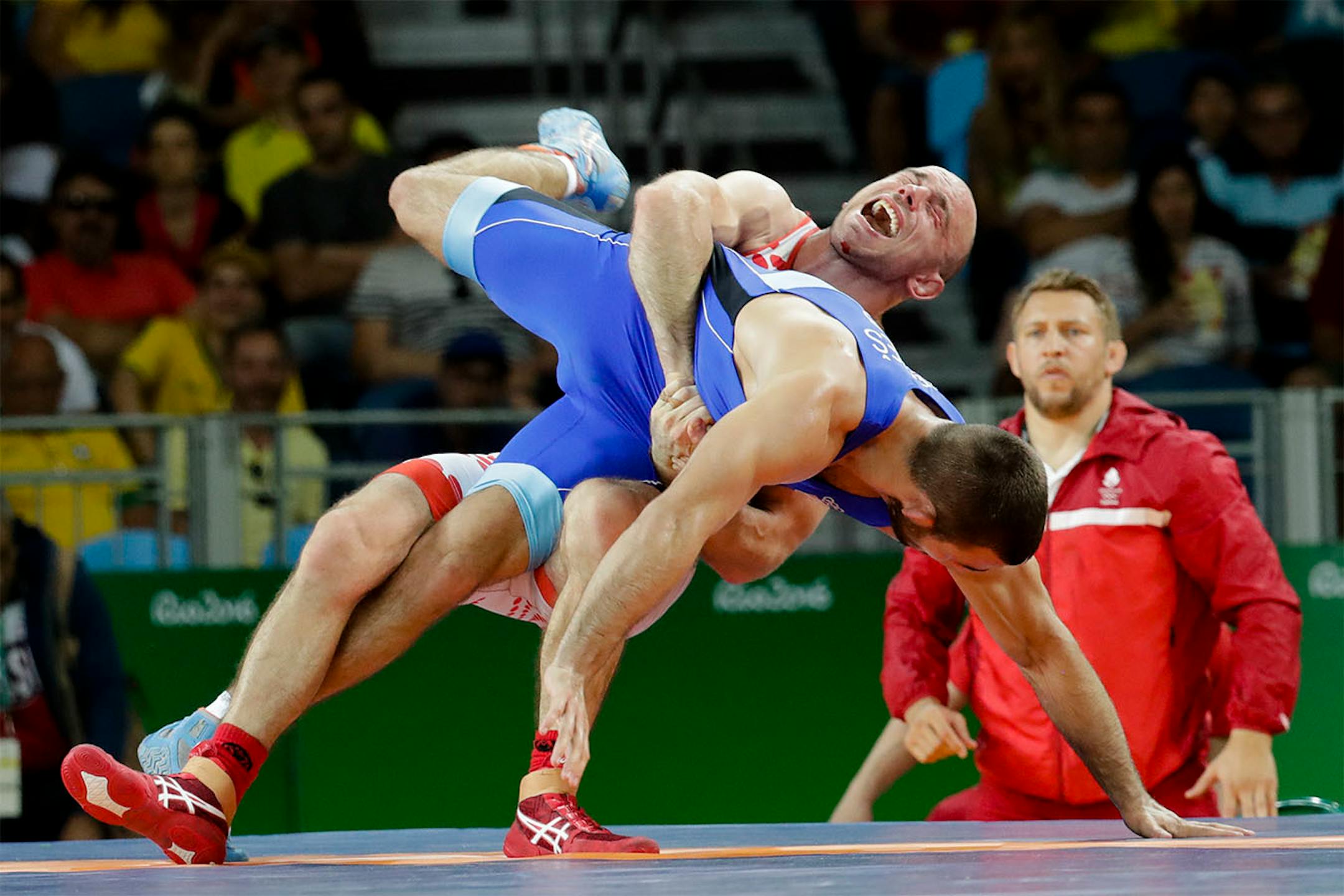 Serbia's Viktor Nemes, blue, competes against Denmark's Mark Overgaard Madsen during the men's wrestling Greco-Roman 75-kg competition at the 2016 Summer Olympics in Rio de Janeiro, Brazil, Sunday, Aug. 14, 2016.